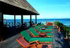 Relaxing sun loungers lined up on the spacious sundeck of the Kapalai water village resort, offering uninterrupted views of the Celebes Sea.