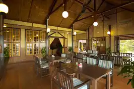 Spacious interior of the restaurant at Lankayan Island Resort, with its high vaulted ceiling and open-air design perfect for enjoying meals.