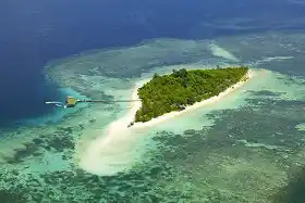 Spectacular aerial view of Lankayan Island, a secluded paradise with white sand beaches and pristine coral reefs, a top luxury dive resort in Sabah.