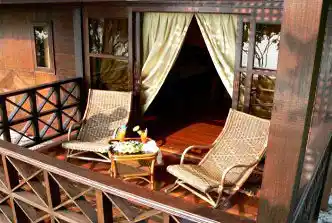 Inviting private balcony of a chalet at Mataking Island Resort, set with drinks and snacks for enjoying a quiet afternoon.