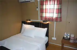 Clean and comfortable budget room at Mabul Inn in Semporna, offering essential amenities for divers and travellers on their way to the islands.