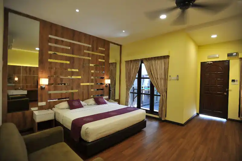Modern and stylish interior of a Garden View Deluxe Room at the luxurious Mataking Island Resort, featuring a decorative feature wall and comfortable furnishings.