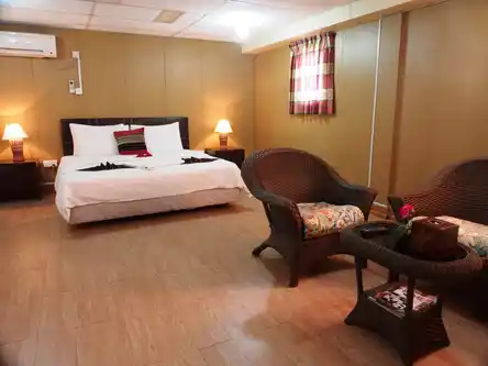 Spacious VIP family room on the Seaventures Dive Rig, offering upgraded comfort with a large double bed and a separate seating area.