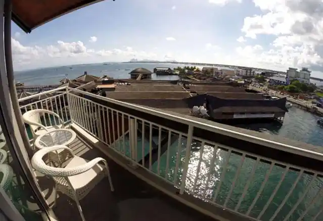 Panoramic seaview from a high-floor balcony at the Pacific Inn, overlooking the bustling waterfront and stilt villages of Semporna.