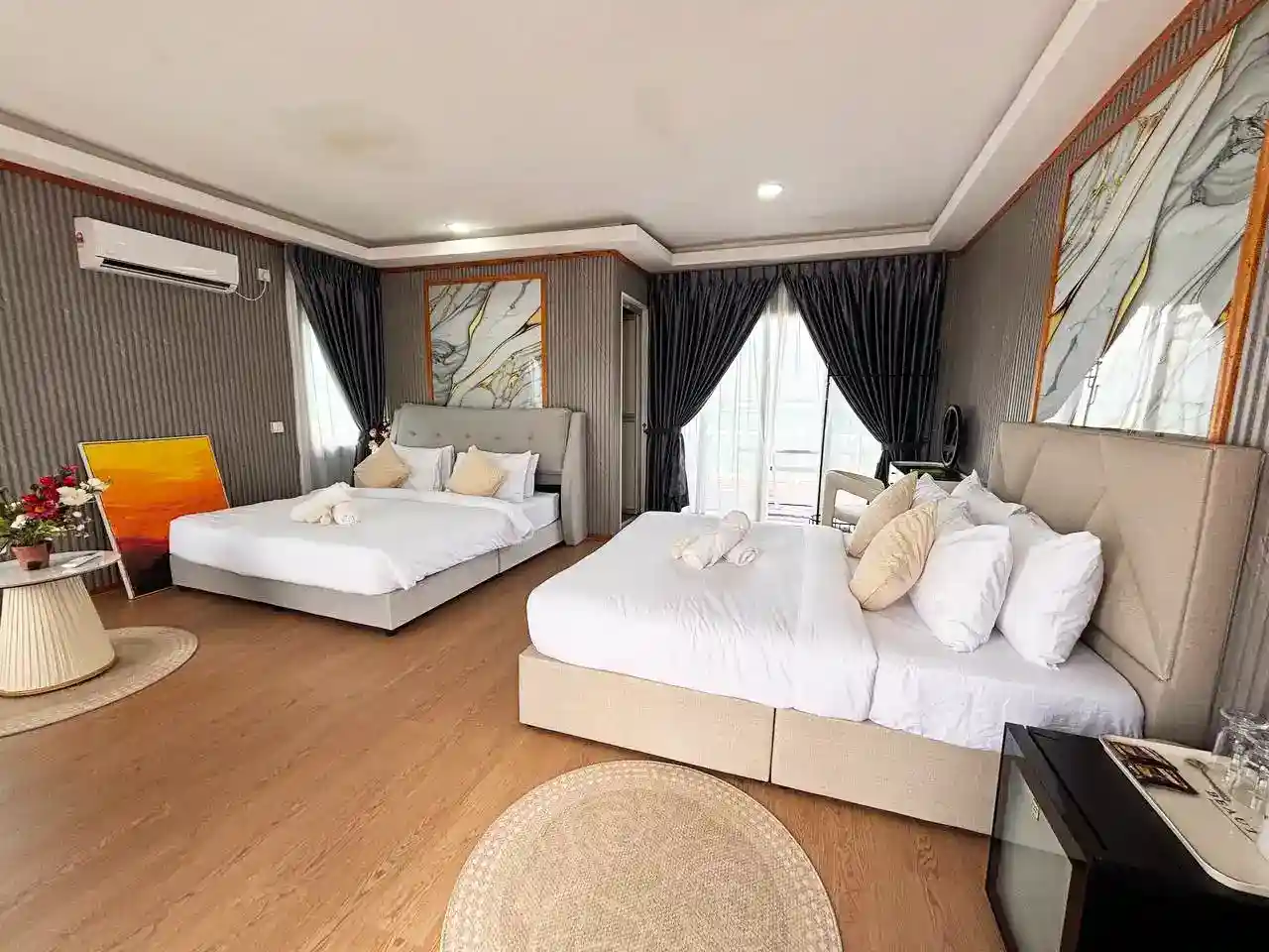 Luxurious and spacious VIP room at Blue Ocean Resort, featuring two large beds, contemporary art, and upscale furnishings for a premium stay.