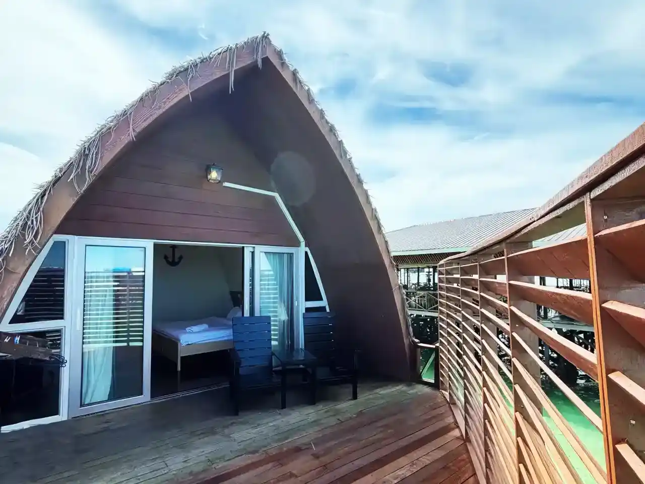 Unique A-frame overwater villa at Crystal Resort Semporna, with a private wooden deck perfect for enjoying the sea breeze.