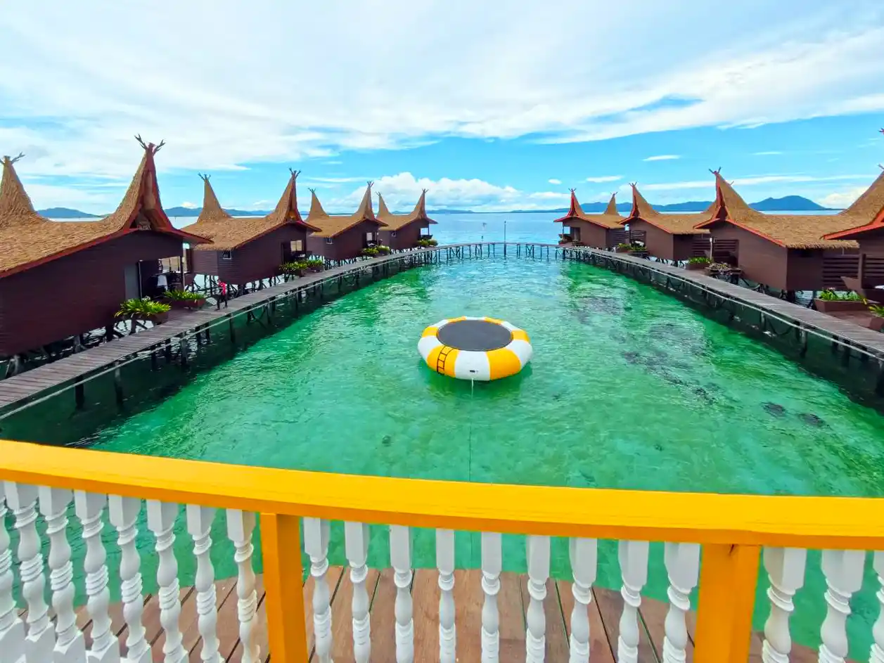 Panoramic view from the main terrace at Dayang Resort, overlooking the beautiful overwater chalets and the giant sea trampoline in the lagoon.
