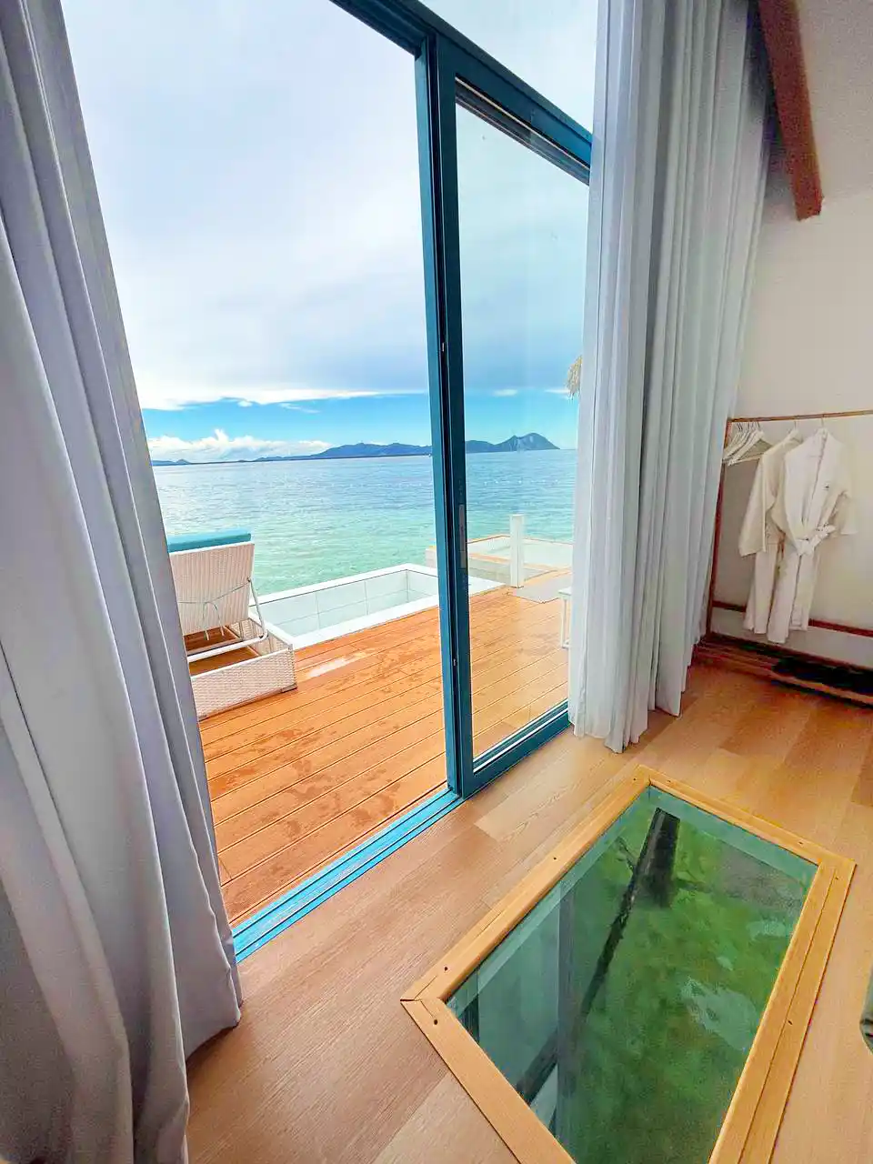 Unique glass floor panel inside a room at Royal Resort Semporna, allowing guests to view the marine life in the water directly below their feet.