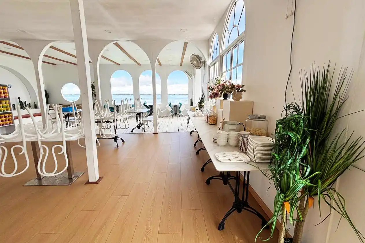 Bright and airy restaurant at Royal Resort Semporna, featuring beautiful archways that provide stunning open-air views of the sea during breakfast.