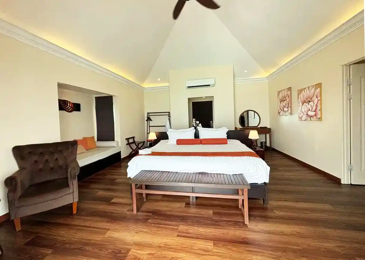 Spacious and elegant bedroom at the Sea Star Resort, featuring a high vaulted ceiling, a king-sized bed, and luxurious furnishings.